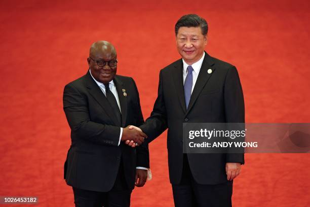 Ghana's President Nana Akufo-Addo shakes hands with China's President Xi Jinping during the Forum on China-Africa Cooperation at the Great Hall of...