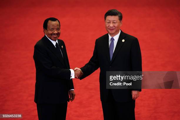 Cameroon President Paul Biya, left, shakes hands with Chinese President Xi Jinping during the Forum on China-Africa Cooperation held at the Great...