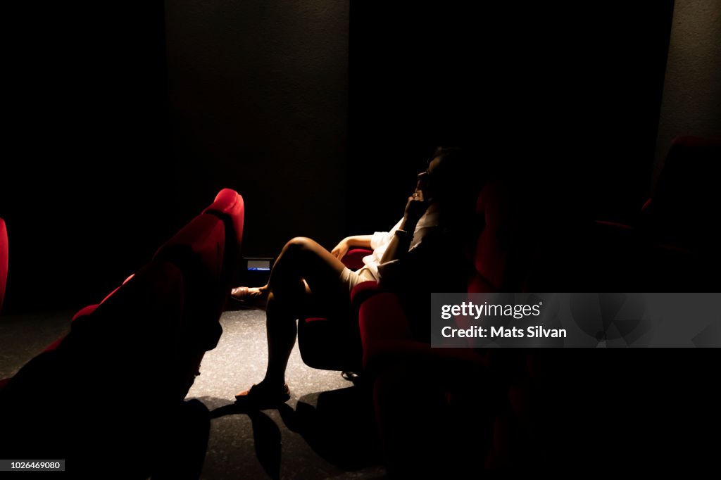 Woman Sitting Alone in Cinema
