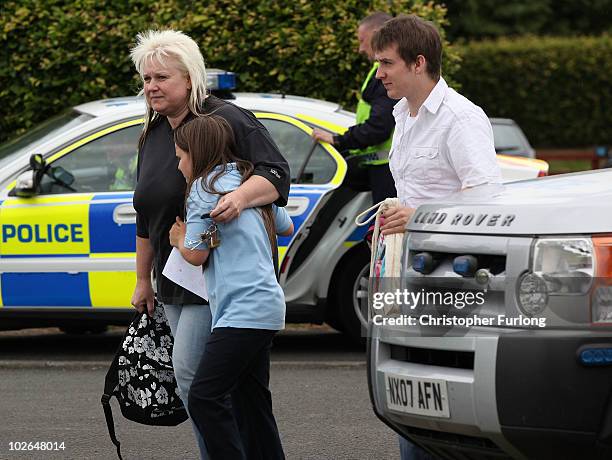 Armed police stand guard as parents collect their children from Dr Thomlinson CE voluntary aided middle school in the village of Rothbury as the...