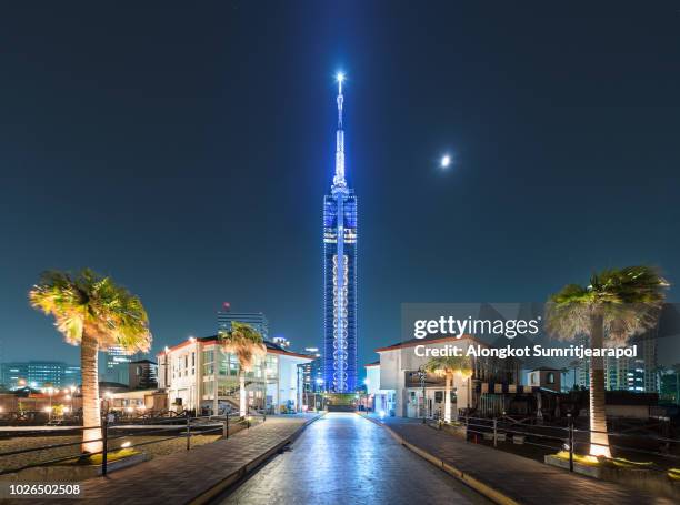 beautiful night view cityscape of the fukuoka tower with light and moon, a tall skyscraper building located in the momochihama area of fukuoka, japan. - fukuoka prefecture stock-fotos und bilder