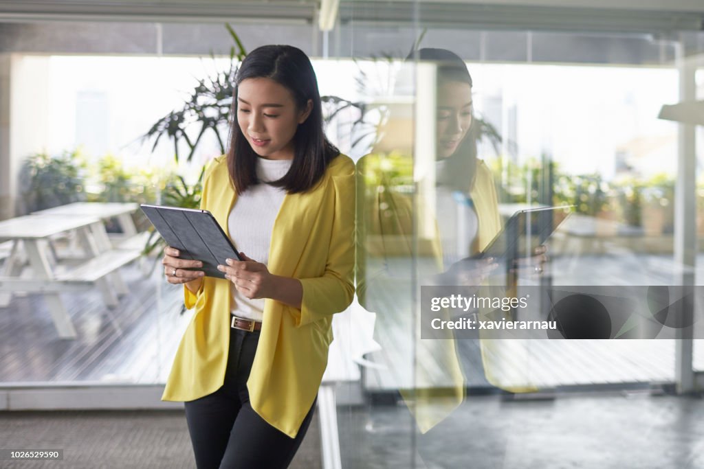 Businesswoman using digital tablet in new office