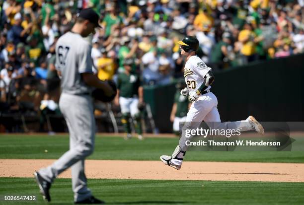 Mark Canha of the Oakland Athletics trots around the bases after hitting a solo home run off of A.J. Cole of the New York Yankees in the bottom of...