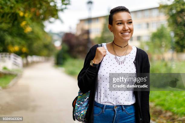 happy female college student on university campus - cute college girl stock pictures, royalty-free photos & images