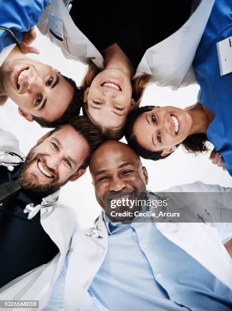 your full circle of care - nurse huddle stock pictures, royalty-free photos & images