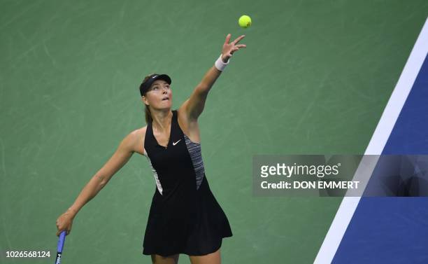 Russia's Maria Sharapova serves to Spain's Carla Suarez Navarro during their 2018 US Open Women's Singles tennis match at the USTA Billie Jean King...