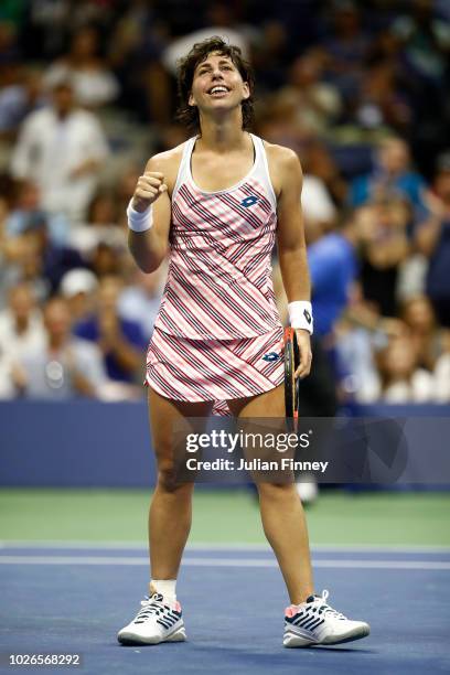 Carla Suarez Nevarro of Spain celebrates match point during her women's singles fourth round match against Maria Sharapova of Russia on Day Eight of...