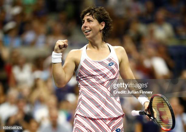 Carla Suarez Nevarro of Spain celebrates match point during her women's singles fourth round match against Maria Sharapova of Russia on Day Eight of...