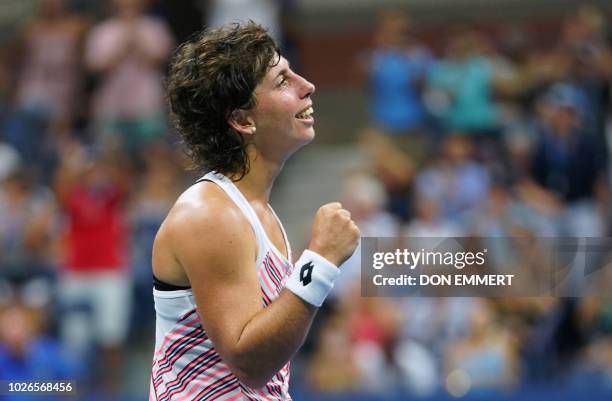 Spain's Carla Suarez Navarro celebrates after defeating Russia's Maria Sharapova during their 2018 US Open Women's Singles tennis match at the USTA...