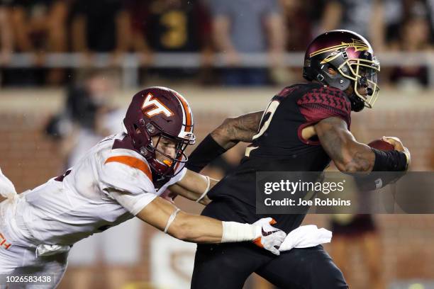 Caleb Farley of the Virginia Tech Hokies sacks Deondre Francois of the Florida State Seminoles in the third quarter of the game at Doak Campbell...