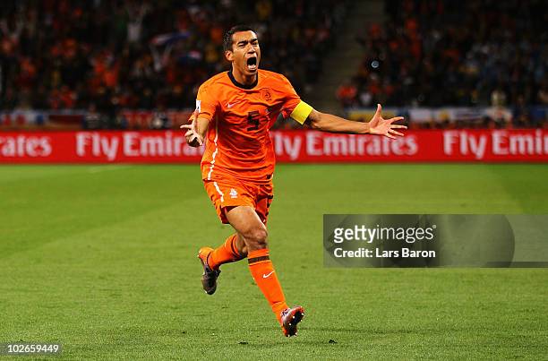 Giovanni Van Bronckhorst of the Netherlands celebrates scoring the opening goal during the 2010 FIFA World Cup South Africa Semi Final match between...