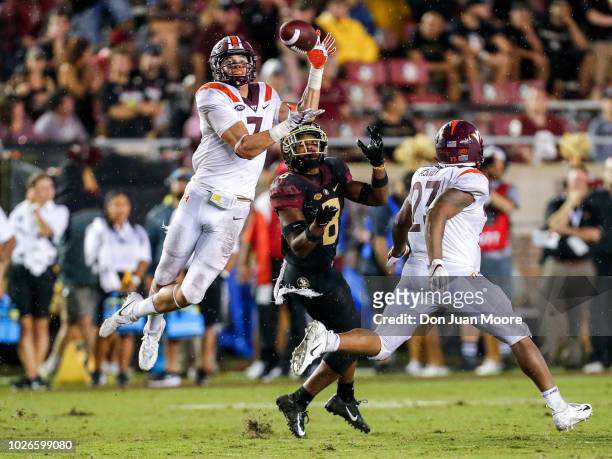 Cornerback Caleb Farley of the Virginia Tech Hokies intercepts the ball over Wide Receiver Nyqwan Murray of the Florida State Seminoles during the...
