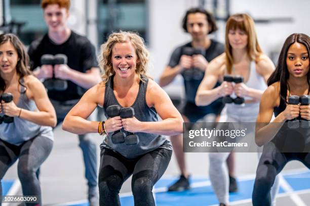 weighted squats - group gym class stock pictures, royalty-free photos & images