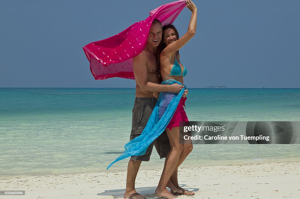 Middle age couple playing on beach