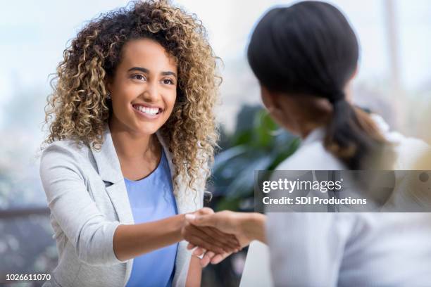 young woman enjoys meeting new therapist - happy customer stock pictures, royalty-free photos & images