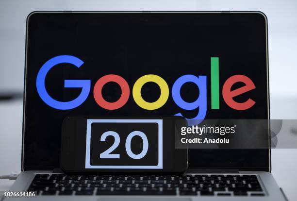 Screen of a mobile phone shows the number of '20' referring to the 20th anniversary of Google as logo of 'Google' technology company is seen on a...