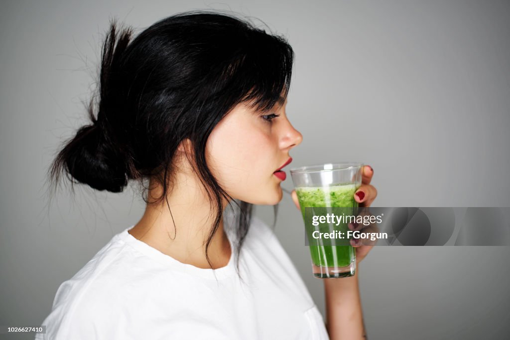 Young woman drinking healthy detox