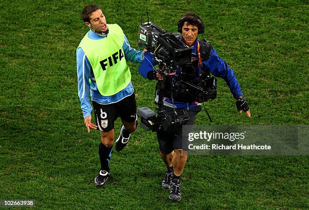 Dejected Mauricio Victorino of Uruguay speaks to a TV camera after being knocked out of the tournament during the 2010 FIFA World Cup South Africa...