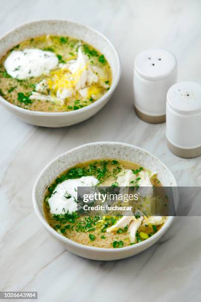 quinoa chicken soup with herby lemon - chicken soup cup stock pictures, royalty-free photos & images
