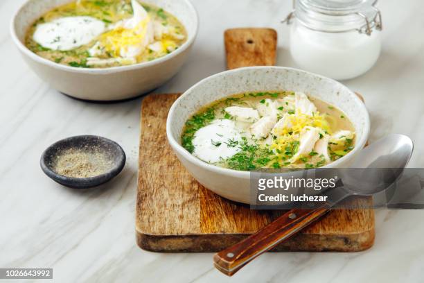 quinoa chicken soup with herby lemon - chicken soup stock pictures, royalty-free photos & images