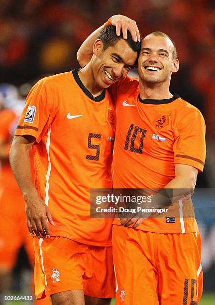 Giovanni Van Bronckhorst and Wesley Sneijder of the Netherlands celebrate victory and a place in the final during the 2010 FIFA World Cup South...