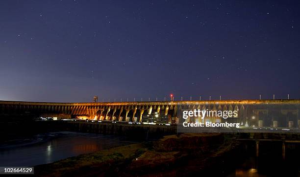 The Itaipu hydroelectric dam stands along the Parana River in Foz do Iguacu, Brazil, at night on Friday, June 18, 2010. The electricity from Itaipu,...