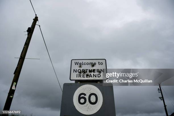 Bullet holes mark a "Welcome to Northern Ireland" sign post that denotes the Irish border on July 22, 2018 in Derrylin, Northern Ireland. Following...