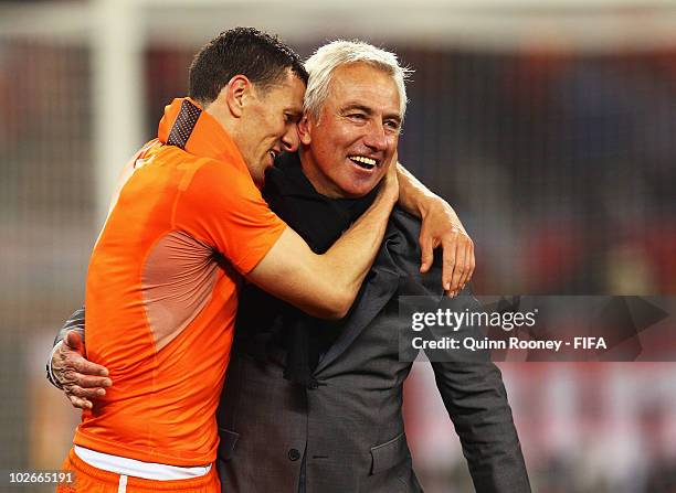 Bert van Marwijk head coach of the Netherlands celebrates with Khalid Boulahrouz after the 2010 FIFA World Cup South Africa Semi Final match between...