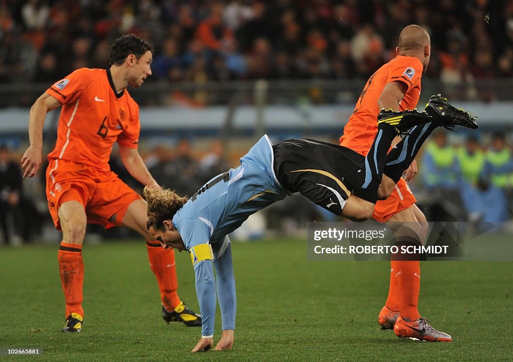 Diego Forlan Ripped Uruguay's striker Diego Forlan falls behind Netherlands' defender ...