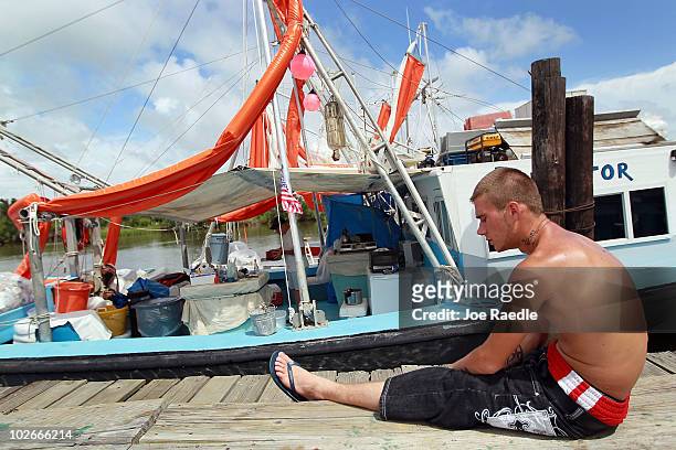 Tony Lebouef, who is a deck hand on a boat hired by BP to help with oil skimming operations, sits near the boat after being forced to stay in due to...