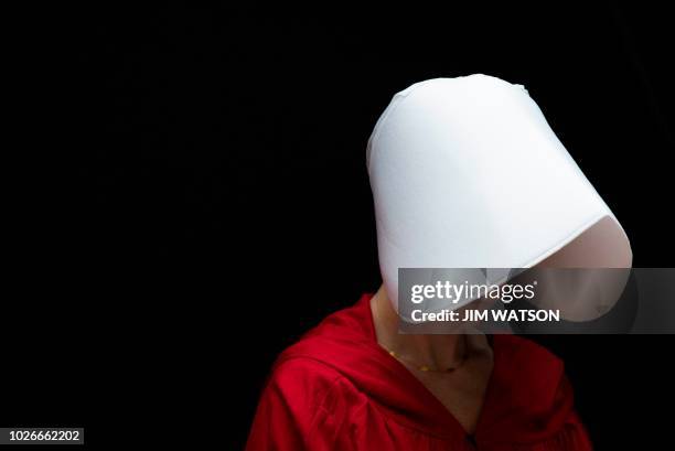 Woman dressed as a character from the novel-turned-TV series "The Handmaid's Tale" walks through the Hart Senate Office Building as Supreme Court...