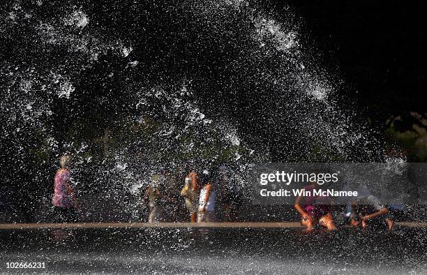 People try to cool off as they sit around the fountains at the National Gallery of Art Sculpture Garden July 6, 2010 in Washington, DC. Temperatures...