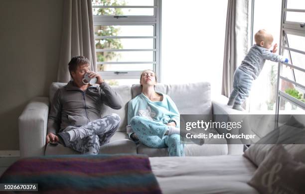 a young family having a lazy day at home. - seat perilous fotografías e imágenes de stock