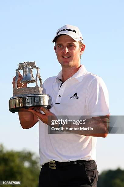 Justin Rose of England celebrates with the AT&T National tournament trophy after he won the tournment following the final round of the AT&T National...