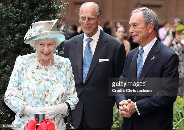 Queen Elizabeth II, Prince Philip, Duke of Edinburgh and Mayor of New York Michael Bloomberg laugh as they visit the British Garden at Hanover Square...