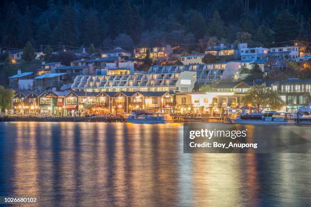 view of queenstown waterfront at night, the most popular town in south island of new zealand. - クイーンズタウン ストックフォトと画像