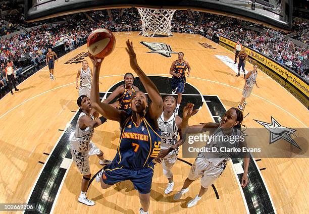 Sandrine Gruda of the Connecticut Sun shoots against Michelle Snow, Sophia Young and Chamique Holdsclaw of the San Antonio Silver Stars on July 6,...