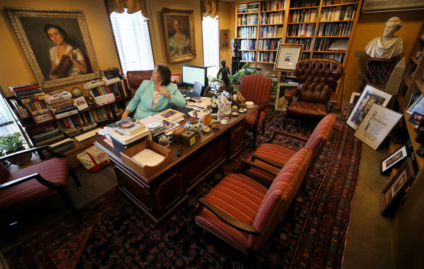 Vita Paladino looks up at a painting of the violinist Erica Morini in her office in Boston on Aug. 24, 2018. Paladino is the director of the Howard...