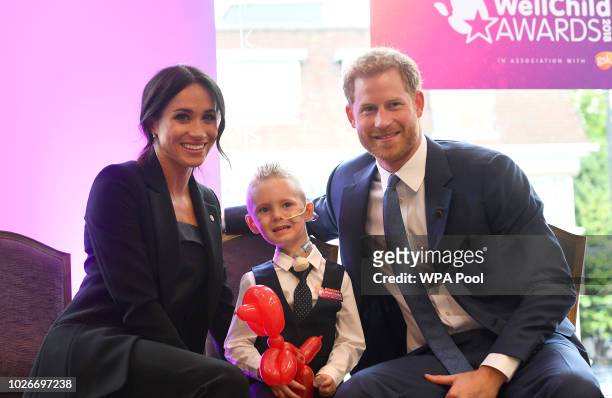 Meghan, Duchess of Sussex and Prince Harry, Duke of Sussex meet four-year-old Mckenzie Brackley during the annual WellChild awards at Royal Lancaster...