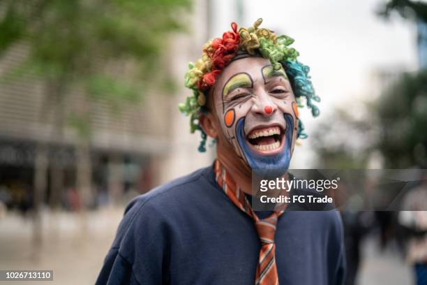 clown makes funny face - clown stock pictures, royalty-free photos & images