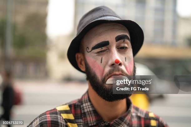 clown makes funny face - sad clown stock pictures, royalty-free photos & images