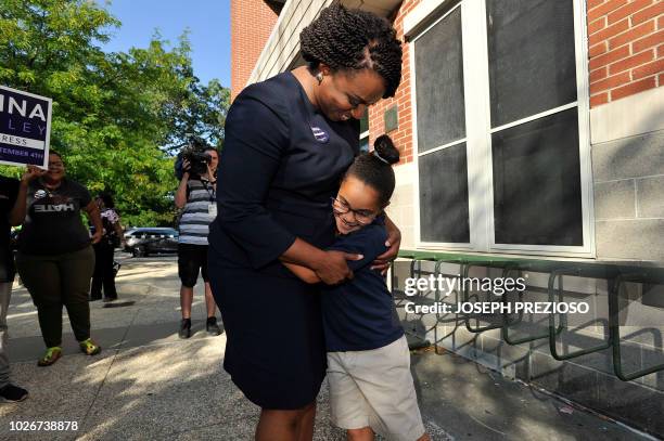 Ayanna Pressley, Democratic candidate for Congress, gets a hug from a girl who said she voted for the candidate at the Mildred Middle School and...