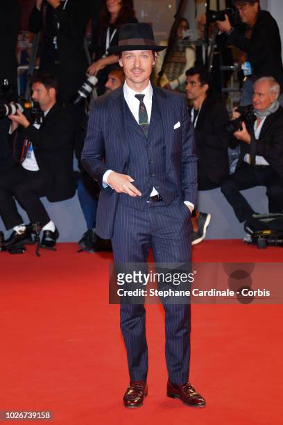 Tom Schilling walks the red carpet ahead of the 'Werk Ohne Autor ' screening during the 75th Venice Film Festival at Sala Grande on September 4, 2018...