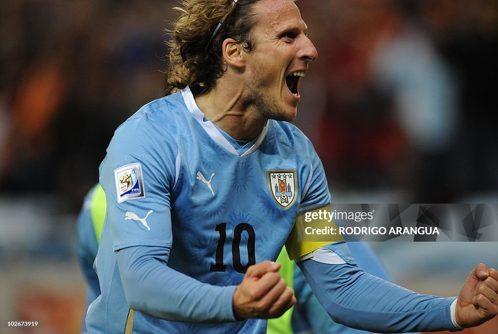 Diego Forlan Ripped Uruguay's striker Diego Forlan celebrates after scoring during the ...