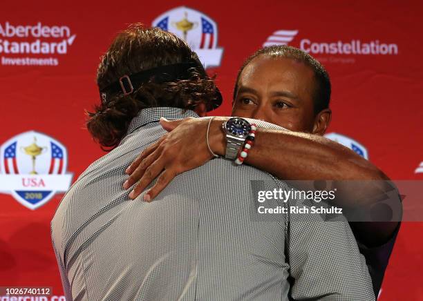 Tiger Woods hugs Phil Mickelson after being introduced along with Bryson DeChambeau by U.S. Ryder Cup Team Captain Jim Furyk, as his Captains Picks...