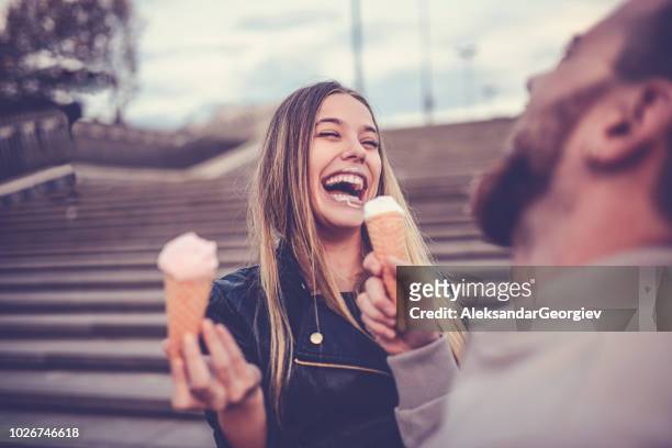 cute female eating ice cream with boyfriend - funny face stock pictures, royalty-free photos & images