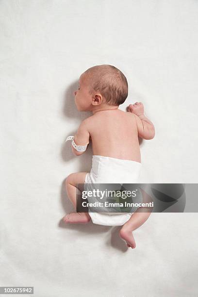 newborn baby lying on front - lying on back ストックフォトと画像