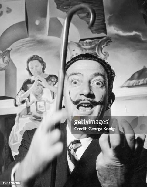 Spanish surrealist artist Salvador Dali in London with one of his paintings entitled 'The Madonna of Port Lligat', December 1951.
