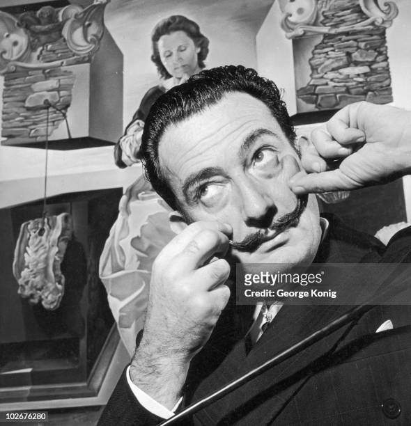 Spanish surrealist artist Salvador Dali in London with one of his paintings entitled 'The Madonna of Port Lligat', December 1951.