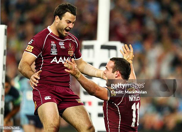 David Shillington of the Maroons rushes to congratulate Nate Myles after he scored during game three of the ARL State of Origin series between the...